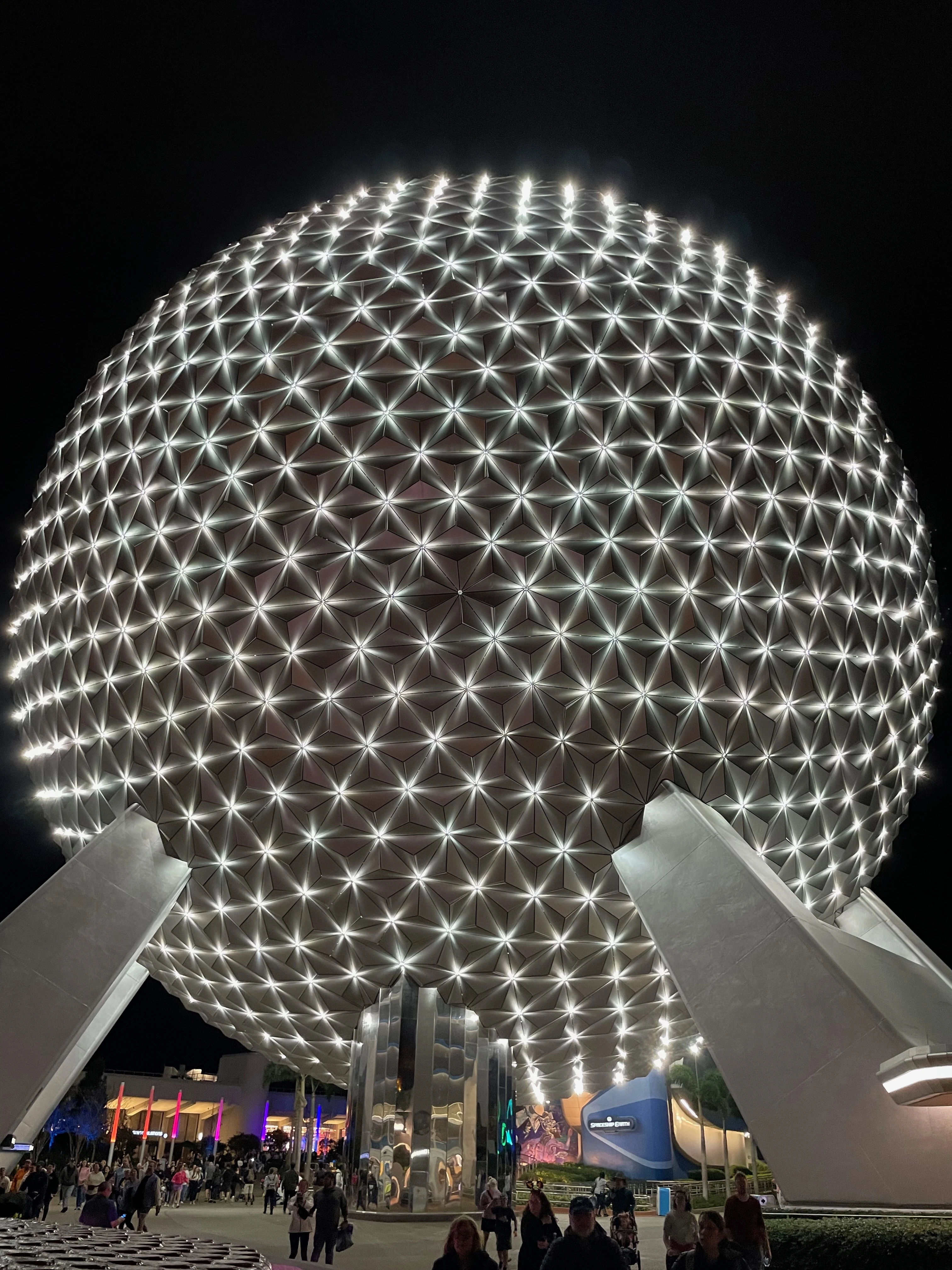 UK family looking tired but happy at Disney World entrance, representing jet lag challenges